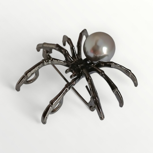 34 - Gun metal and simulated pearl spider brooch. Shipping group (A).