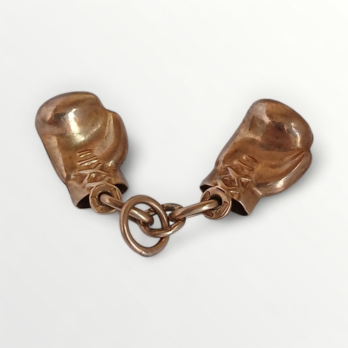 78 - 9ct gold pendant in the form of boxing gloves, 2.2g. Shipping group (A).