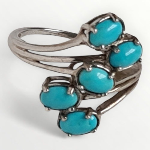 12 - A 925 silver and turquoise cabochon crossover ring, size U. Shipping group (A).