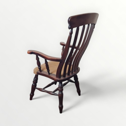 123 - 20th century 'Country kitchen' slat back armchair, having later seat padding. 47cm to seat 114cm ove... 