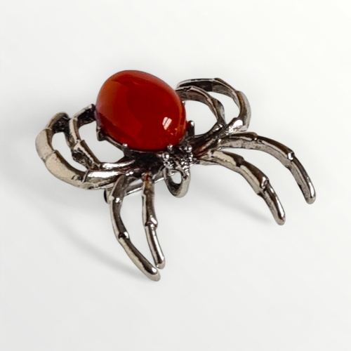 16 - Red stone set spider brooch. Shipping group (A).