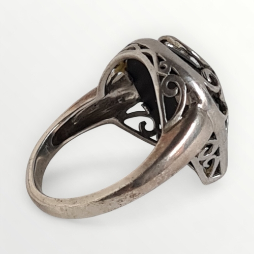 44 - A scroll-caged 925 silver and onyx cabochon ring, size S. Shipping group (A).