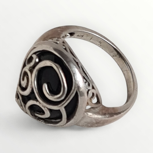 44 - A scroll-caged 925 silver and onyx cabochon ring, size S. Shipping group (A).