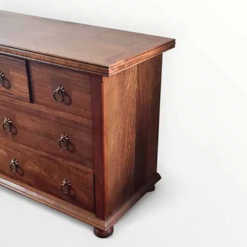 298 - Modern mixed wood multi drawer double width chest, having metal ring drop handles. 81 x 145 x 50cm.