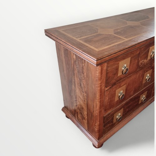 298 - Modern mixed wood multi drawer double width chest, having metal ring drop handles. 81 x 145 x 50cm.