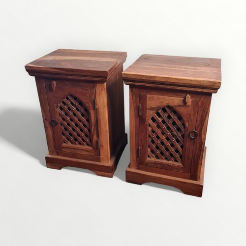 300 - A pair of modern sheesham wood bedside cupboards each having lattice grill fronts. 60 x 39.4cm.