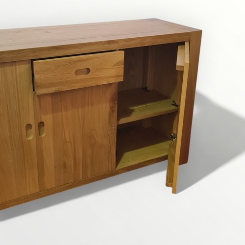 304 - Modern light oak side board having central drawer over cupboard door, flanked by two larger cupboard... 