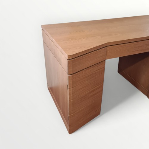 312 - As new designer modern light oak desk, having central slide out keyboard shelf flanked by two drawer... 