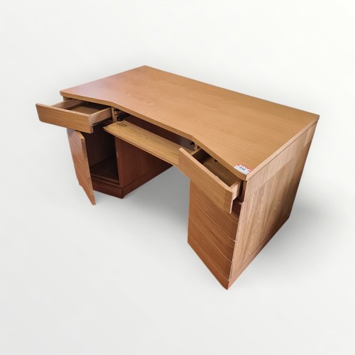 312 - As new designer modern light oak desk, having central slide out keyboard shelf flanked by two drawer... 