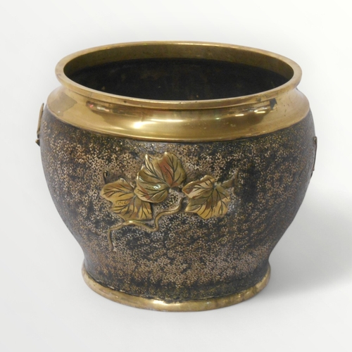 149 - A cast brass probably Oriental jardiniere with grape and vine relief decoration. 22cm high. Shipping... 