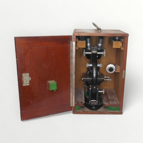 128 - C. Baker of London a binocular microscope with four lens turret and two way adjustable stage. Plano-... 