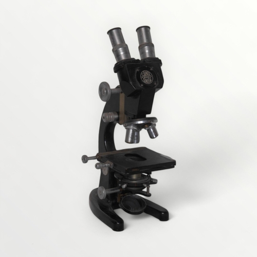 128 - C. Baker of London a binocular microscope with four lens turret and two way adjustable stage. Plano-... 