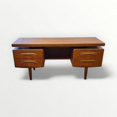 133 - G Plan teak dressing table with 'floating' top over two columns of two drawers. 71 x 152 x 46cm.