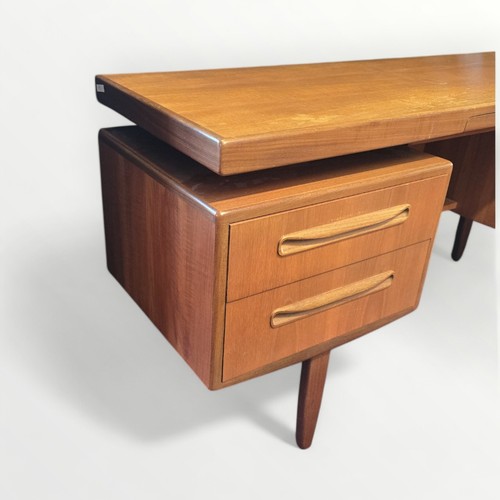 133 - G Plan teak dressing table with 'floating' top over two columns of two drawers. 71 x 152 x 46cm.