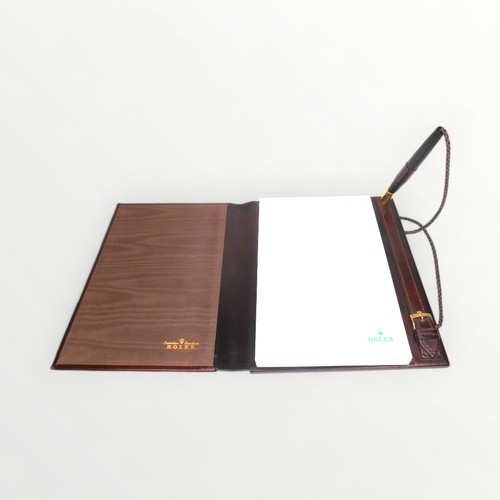 14 - Rolex branded leather covered desk top note pad and pen, 31cm deep. Shipping group (A).