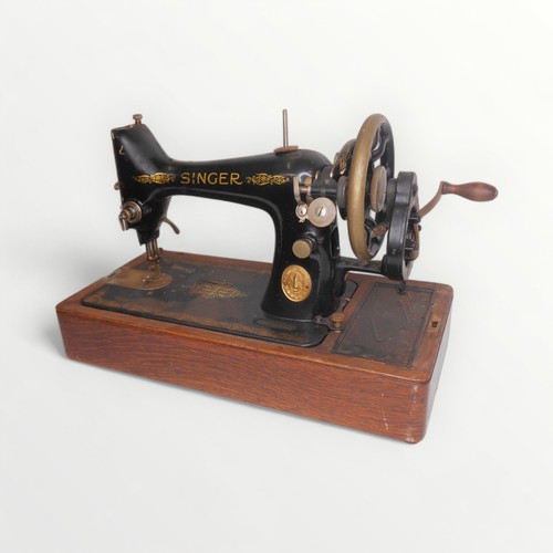 22 - Wooden cased Singer sewing machine.