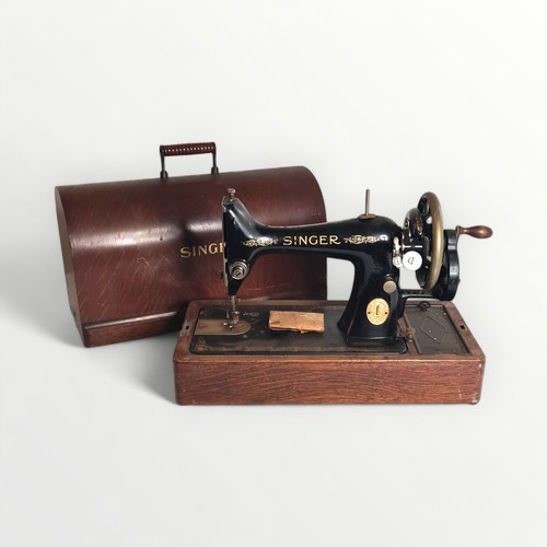 22 - Wooden cased Singer sewing machine.