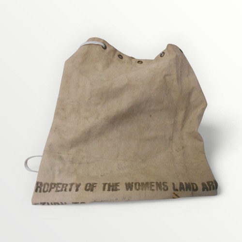 31 - A rare wartime canvas knapsack, stencilled 'Property of the Womens Land Army'. 76cm in length. Shipp... 