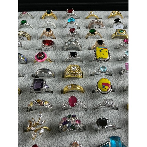 46 - Dealers Tray of Dress Rings - 100 rings of various designs and sizes. Gold and Silver tones with a v... 