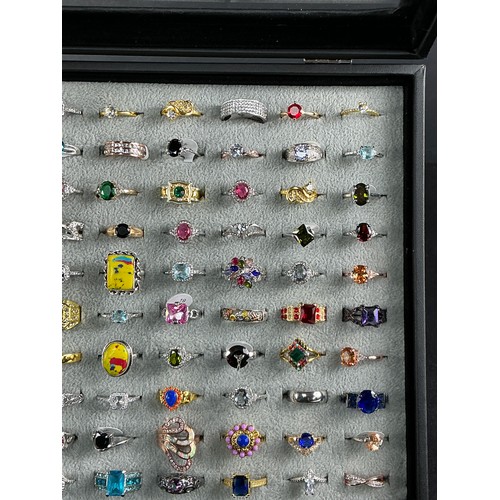 46 - Dealers Tray of Dress Rings - 100 rings of various designs and sizes. Gold and Silver tones with a v... 