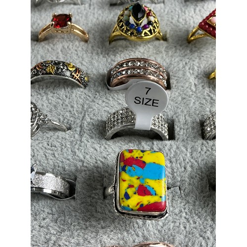 47 - Dealers Tray of Dress Rings - 100 rings of various designs and sizes. Gold and Silver tones with a v... 