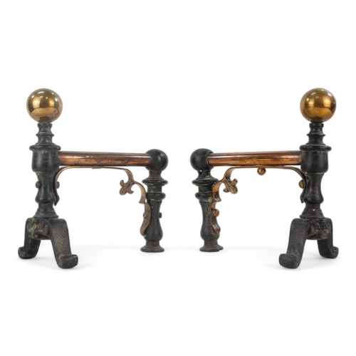 11 - A pair of iron and copper fire dogs - in the decorative arts style with ball finials, 22cm high.