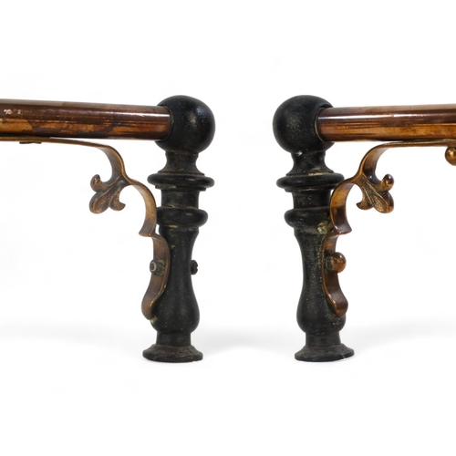 11 - A pair of iron and copper fire dogs - in the decorative arts style with ball finials, 22cm high.