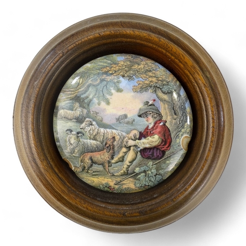 14 - A 19th century Prattware pot lid - view of Pegwell Bay, 10cm diameter, within a wooden frame, togeth... 