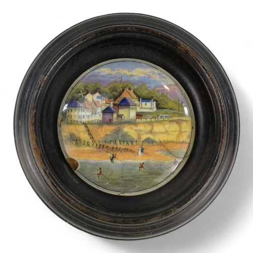 14 - A 19th century Prattware pot lid - view of Pegwell Bay, 10cm diameter, within a wooden frame, togeth... 