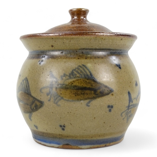 153 - A 20th century British ceramic lidded pot - decorated with fish, incised with initials to base, 11cm... 