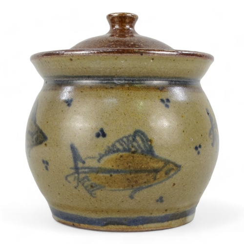 153 - A 20th century British ceramic lidded pot - decorated with fish, incised with initials to base, 11cm... 