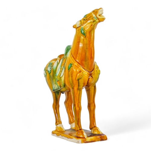 155 - A 20th century Sancai glazed model of a horse - in the Tang style, standing on rectangular base, 20c... 