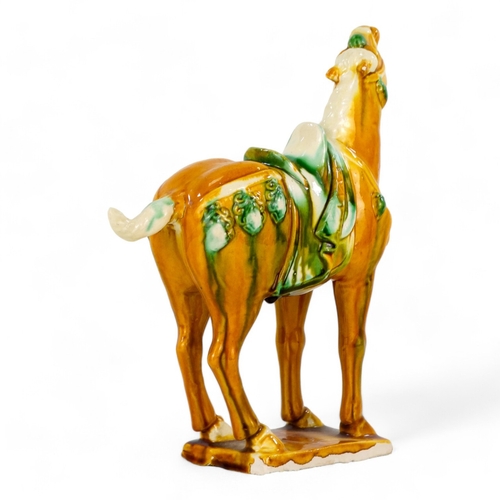 155 - A 20th century Sancai glazed model of a horse - in the Tang style, standing on rectangular base, 20c... 