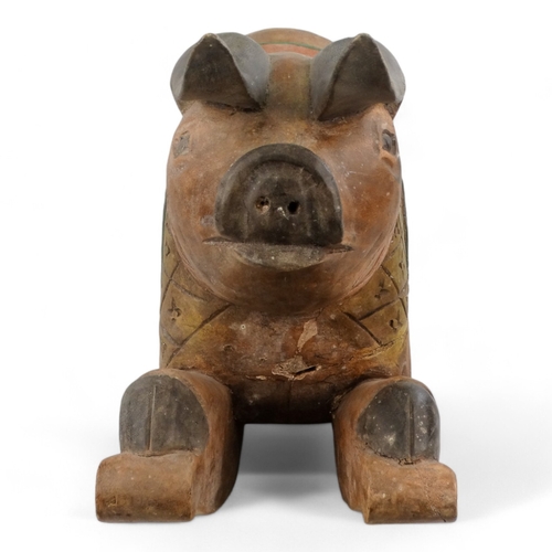 23 - A polychrome painted hardwood rocking pig - the squatting hog with a diaper carved panel on rockers,... 