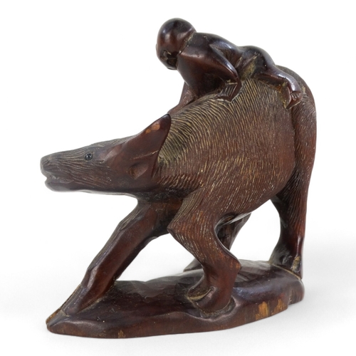 262 - An early 20th century carved hardwood figure - seated astride a wild ox, 15cm wide.