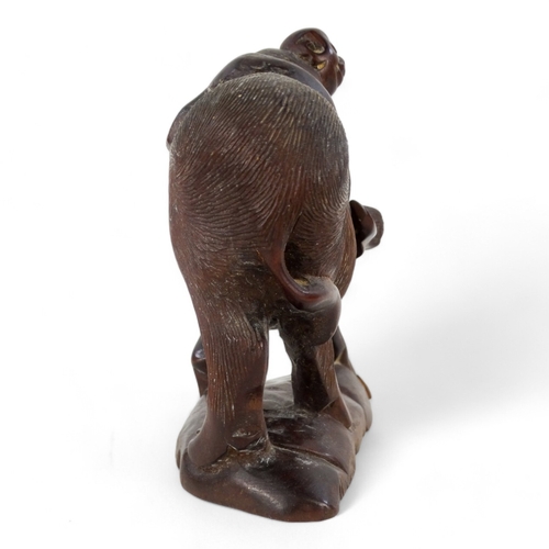 262 - An early 20th century carved hardwood figure - seated astride a wild ox, 15cm wide.