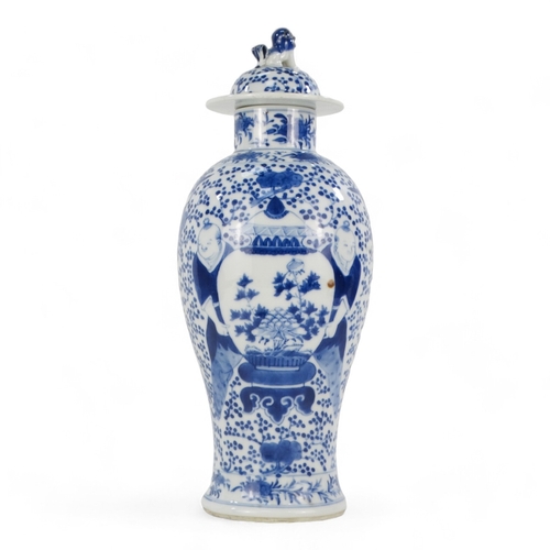 264 - A late 19th century Chinese blue and white vase - lidded and of baluster form and decorated with fig... 