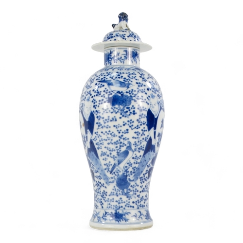 264 - A late 19th century Chinese blue and white vase - lidded and of baluster form and decorated with fig... 