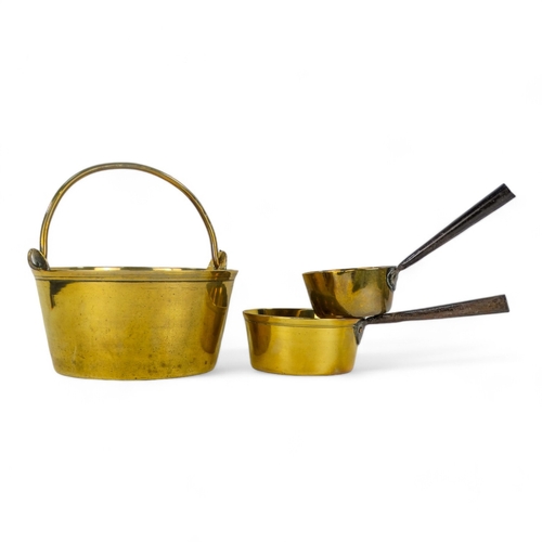 30 - A late 19th century brass jam pan - with swing handle, 27cm diameter, together with two small saucep... 