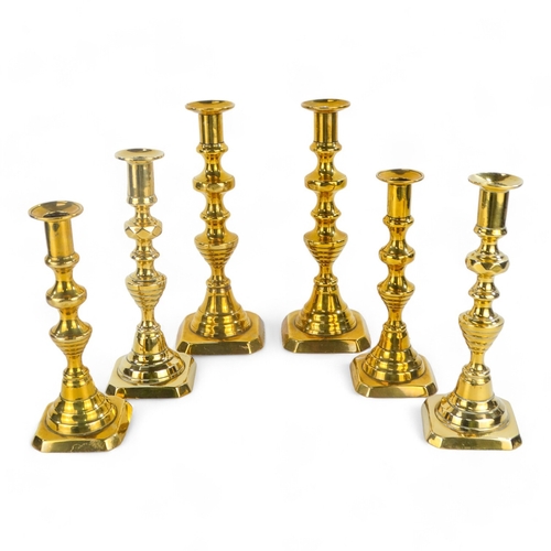 32 - A pair of 19th century brass candlesticks - of baluster form, with square canted bases, 23cm high, t... 