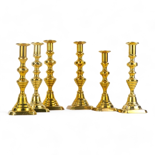 32 - A pair of 19th century brass candlesticks - of baluster form, with square canted bases, 23cm high, t... 