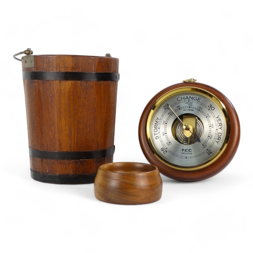 34 - A late 20th century aneroid barometer - circular and mounted on a beech base, 20cm diameter, togethe... 