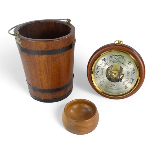 34 - A late 20th century aneroid barometer - circular and mounted on a beech base, 20cm diameter, togethe... 