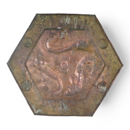 5 - An early 20th century copper wall plaque - hexagonal repousse decorated with three fish, 34cm wide.