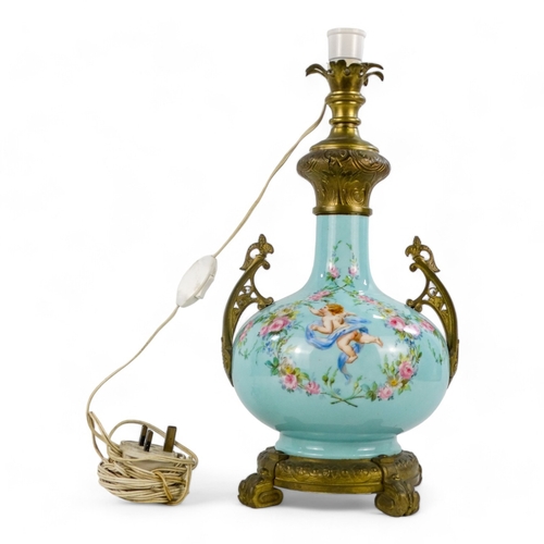 9 - An early 20th century French ceramic table lamp - of blue baluster form and decorated with cherubs a... 