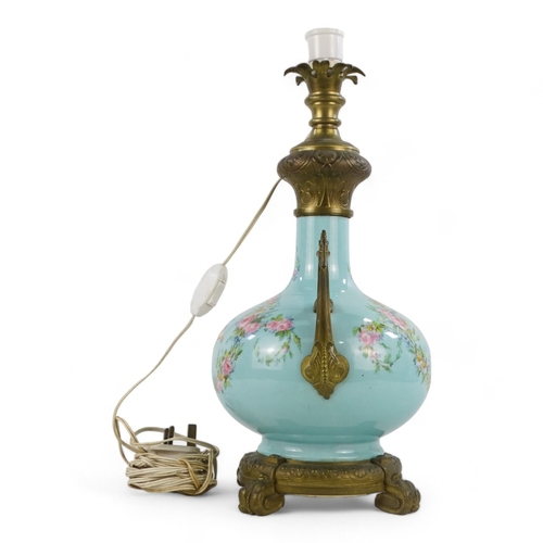 9 - An early 20th century French ceramic table lamp - of blue baluster form and decorated with cherubs a... 