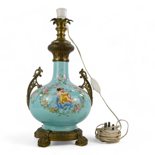 9 - An early 20th century French ceramic table lamp - of blue baluster form and decorated with cherubs a... 