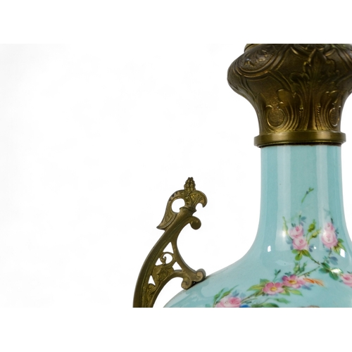 9 - An early 20th century French ceramic table lamp - of blue baluster form and decorated with cherubs a... 