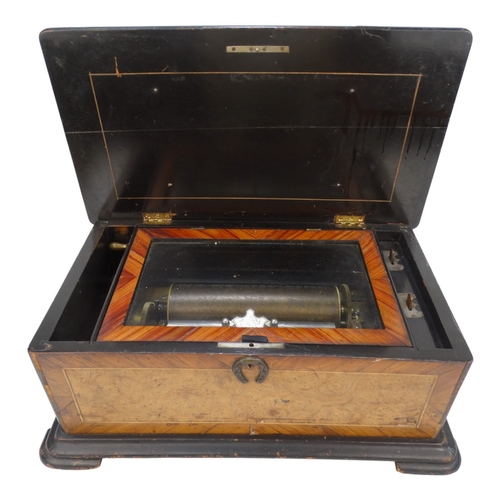 10A - A 19th century Swiss cylinder music box - walnut and amboyna veneered box, the cylinder playing six ... 