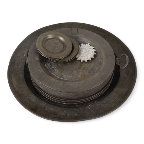 118 - A pewter charger - diameter 37.5cm, together with seven pewter plates, a pewter warming dish and oth... 